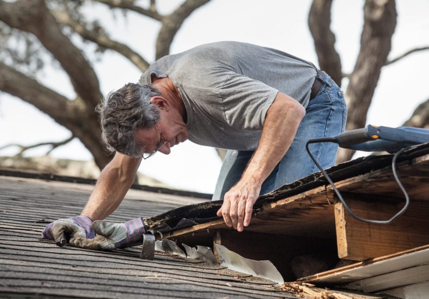 man is trying to extend roof life